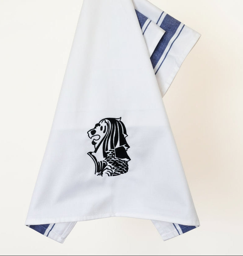 White tea owel with a navy blue Singapore Merlion embroidery and blue stripes